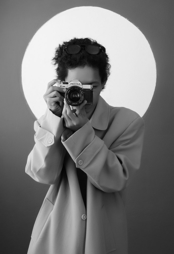 woman coat camera photographer 7883774